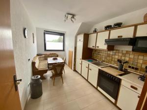 a kitchen with a table and a dining room at Apartment Anita in Bottrop