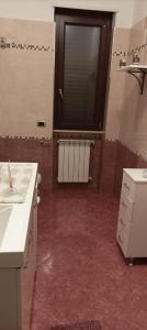 a kitchen with red flooring and a large window at B&B CASA NISI in Villa Castelli +22 photos
