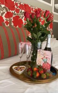a tray with a bottle of wine and a vase of flowers at My Guest in Florence in Florence