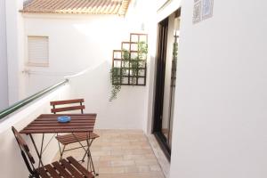 un patio con una mesa y 2 sillas y una escalera en Old Town Apartments 2D, en Albufeira