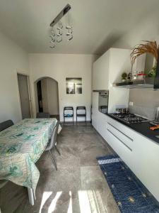 a bedroom with a bed and a kitchen with a stove at Beautiful Naxos House in Giardini Naxos