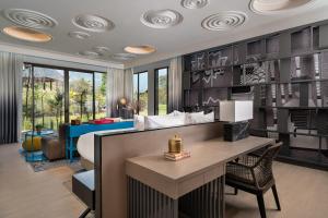 a bedroom with a bed and a desk in a room at Norbu The Montanna, Dharamshala - IHCL SeleQtions in Dharamshala