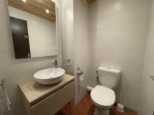 a bathroom with a sink and a toilet and a mirror at CRYSTAL 25 - Duplex centre village et proche pistes, vue montagnes - Garage in La Clusaz