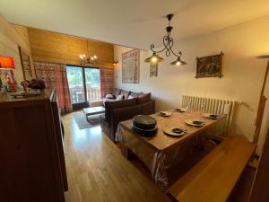 a living room with a table and a couch at CRYSTAL 25 - Duplex centre village et proche pistes, vue montagnes - Garage in La Clusaz +11 photos
