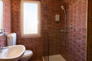 a bathroom with a shower and a toilet and a sink at Rooms Gašper in Postojna