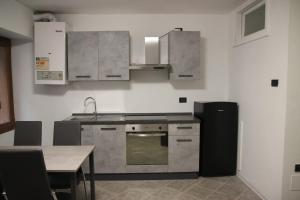 a kitchen with stainless steel appliances and a table at Homemade Lake in Desenzano del Garda
