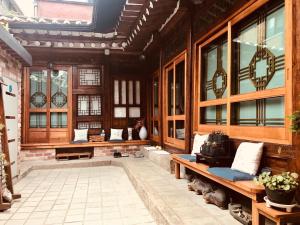 a large room with wooden walls and windows at Hanok Guesthouse Suni in Seoul
