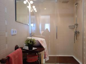 a bathroom with a shower with a sink and a mirror at Apt playa de Muro ca n Ines - 1ª linea de playa in Port d'Alcudia