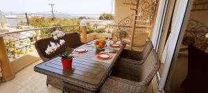 a table and chairs on a balcony with a table at Katerina's Residence Chania With Panoramic View in Perivólia