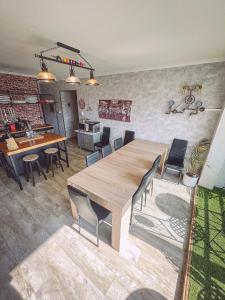 a dining room with a wooden table and chairs at Africa panoramique By Carl-Emilie in Épinal +20 photos