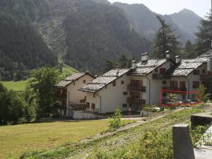 a row of houses on a hill with mountains in the background at Appartamento Gressoney-Saint-Jean (Obre Biel) - I Larici in Gressoney-Saint-Jean +3 photos