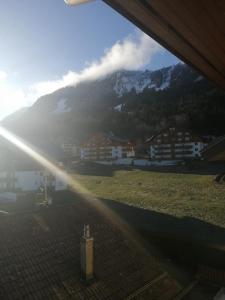 a view of a mountain from a window of a building at Le balcon des Memises in Thollon