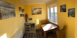 a yellow room with a table and a window at Old School - Exclusive 5 Room private suite in Orkney