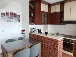 a kitchen with a counter and a brick wall at Margareta's Apartment in Kaštela