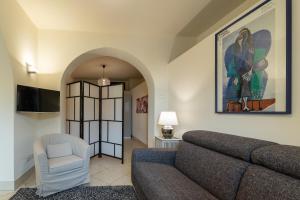 a living room with a couch and a chair at Casa Belvedere in Piedimonte Etneo