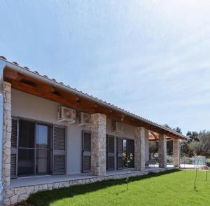 a rendering of a house with stone pillars at Villa Kadila with heated pool and sauna for family in Lun