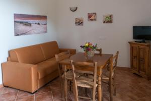 uma sala de estar com um sofá e uma mesa em Agriturismo De Santis em Castiglioncello