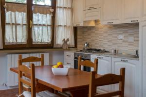 a kitchen with a wooden table with a bowl of fruit on it at Agriturismo De Santis in Castiglioncello