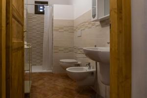a bathroom with a toilet and a sink at Agriturismo De Santis in Castiglioncello