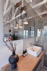 a bathroom with a sink and a large mirror at Ikaros Suites in Amoudara Herakliou