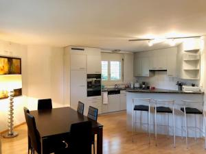 a kitchen and dining room with a table and chairs at Centrally located, Spacious Modern Apartment in Zürich