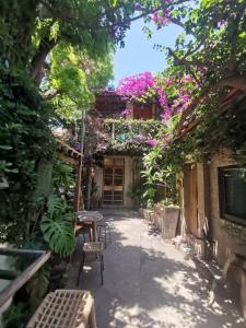 a courtyard with a table and chairs and flowers at Dear B&B in Anping
