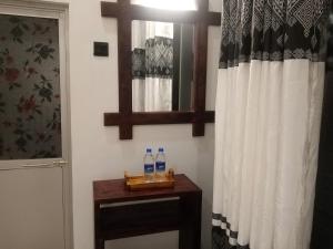 a bathroom with two bottles of water on a table at Ridge Boundary View in Dambulla