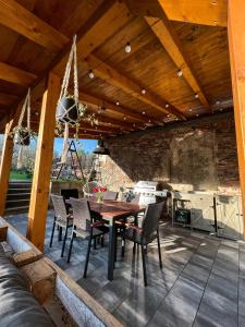 an outdoor dining area with a table and chairs at Penzion Nový Svět in Krásno