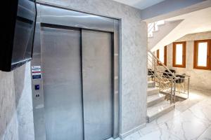 a metal elevator in a room with stairs at RENT HOUSE ANEMOS in Iraklitsa