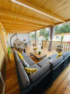 a living room with a couch and a wooden ceiling at Iris Holiday Homes - Camping park Soline in Biograd na Moru