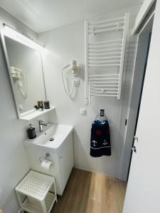 a bathroom with a sink and a bag on the wall at Iris Holiday Homes - Camping park Soline in Biograd na Moru