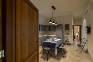 a dining room and kitchen with a table and chairs at Casa Belvedere in Piedimonte Etneo