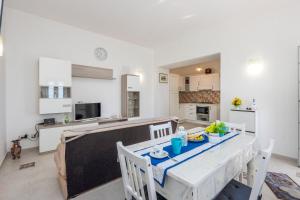 a kitchen and dining room with a table and chairs at Villa Salice in Amalfi