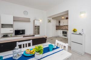 a kitchen and living room with a table and chairs at Villa Salice in Amalfi +34 photos
