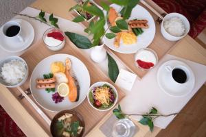 a table with plates of food and bowls of rice at Hotel Grand View Takasaki in Takasaki