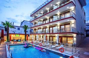 a hotel with a swimming pool in front of a building at RENT HOUSE ANEMOS in Iraklitsa