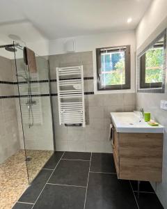 a bathroom with a shower and a sink at Le Cube des Garrigues in Vallérargues +18 photos