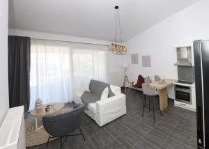 a living room with a white couch and a table at Sea View in Keramoti