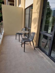 a patio with two chairs and a table in a building at СТУДИО АВА in Sliven