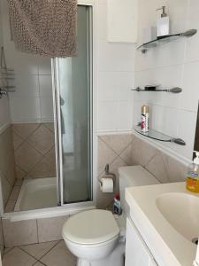 a bathroom with a shower and a toilet and a sink at B1001 Ocean View in Bloubergstrand