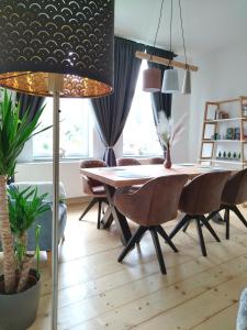 a dining room with a table and chairs at FeRo´s Ferienwohnung in Wernigerode