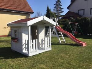 a play house with a slide in a yard at OW Delta in Rewal