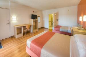 a hotel room with two beds and a desk at Motel 6-Niantic, CT - New London in Niantic