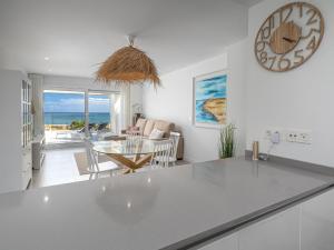 a kitchen and living room with a view of the ocean at Via Celere 2376 Beach & Golf in San Luis de Sabinillas