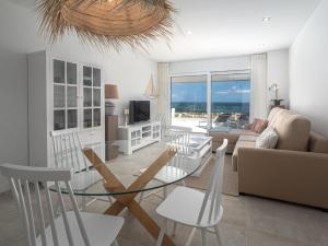 a living room with a glass table and chairs at Via Celere 2376 Beach & Golf in San Luis de Sabinillas