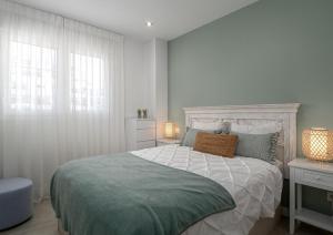 a bedroom with a large bed and a window at Via Celere 2376 Beach & Golf in San Luis de Sabinillas +31 photos