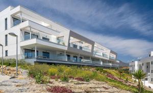 a large white building on a hill with a sky at Via Celere 2376 Beach & Golf in San Luis de Sabinillas