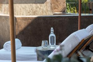 stół ze szklaną butelką i kieliszkami na stole w obiekcie Hotel Grand María w mieście Morelia