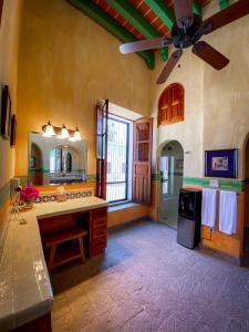 a large kitchen with a ceiling fan and a sink at Hotelito Álamos in Álamos