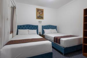 Postel nebo postele na pokoji v ubytování Hotel Rojas Inn